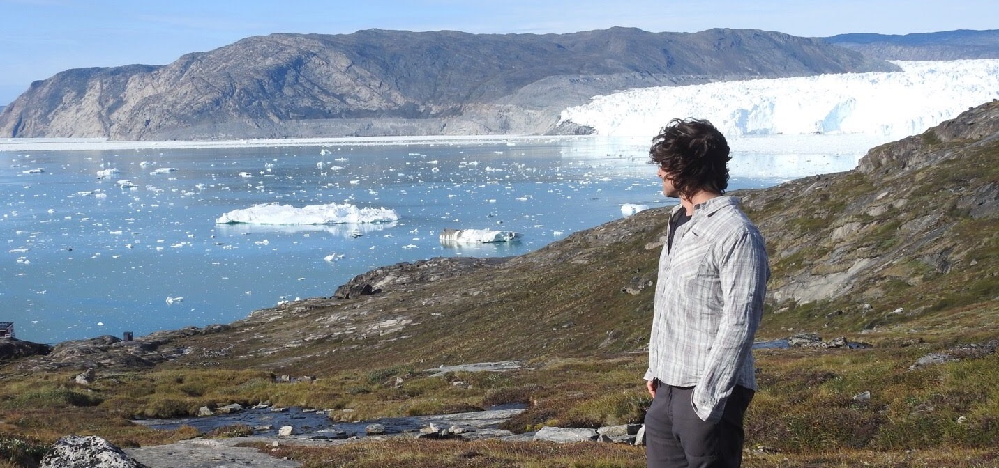 Jon overlooking icebergs and a glacier in Greenland